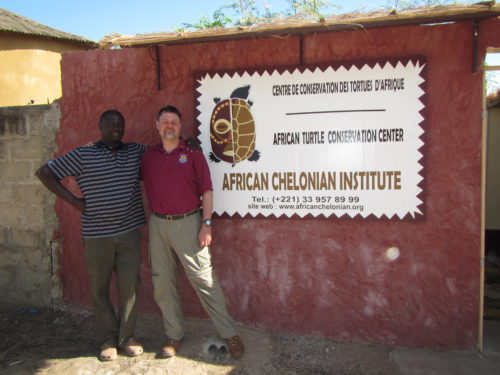 Tomas Diagne (ACI Director) with Thomas Leuterlitz (USFWS-CITES) next to the entrance sign of the Rhodin Center-Ngaparou-Senegal